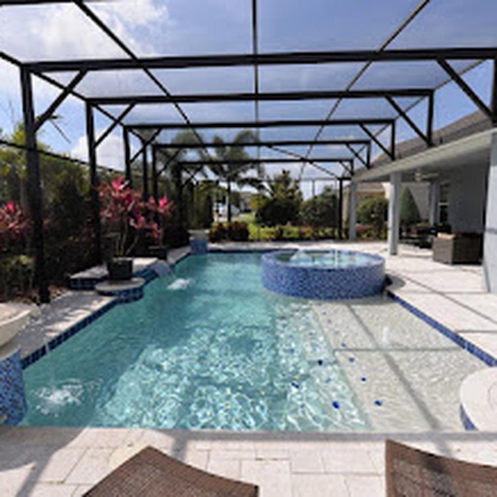 Pool and raised spa under a panoramic screen enclosure with stone deck, Jacksonville